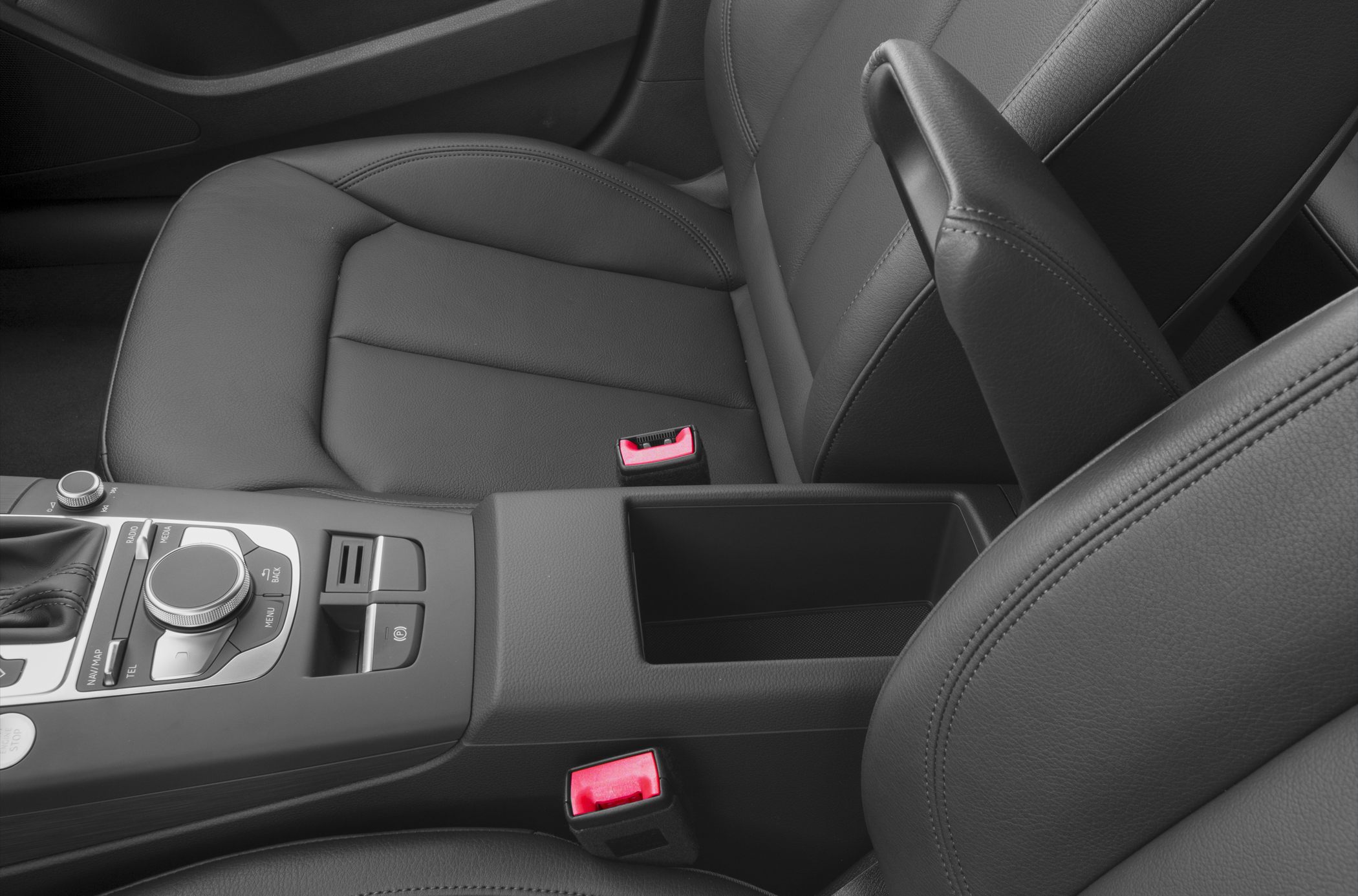 Close-up of interior center console and seats with control knob and gear selector