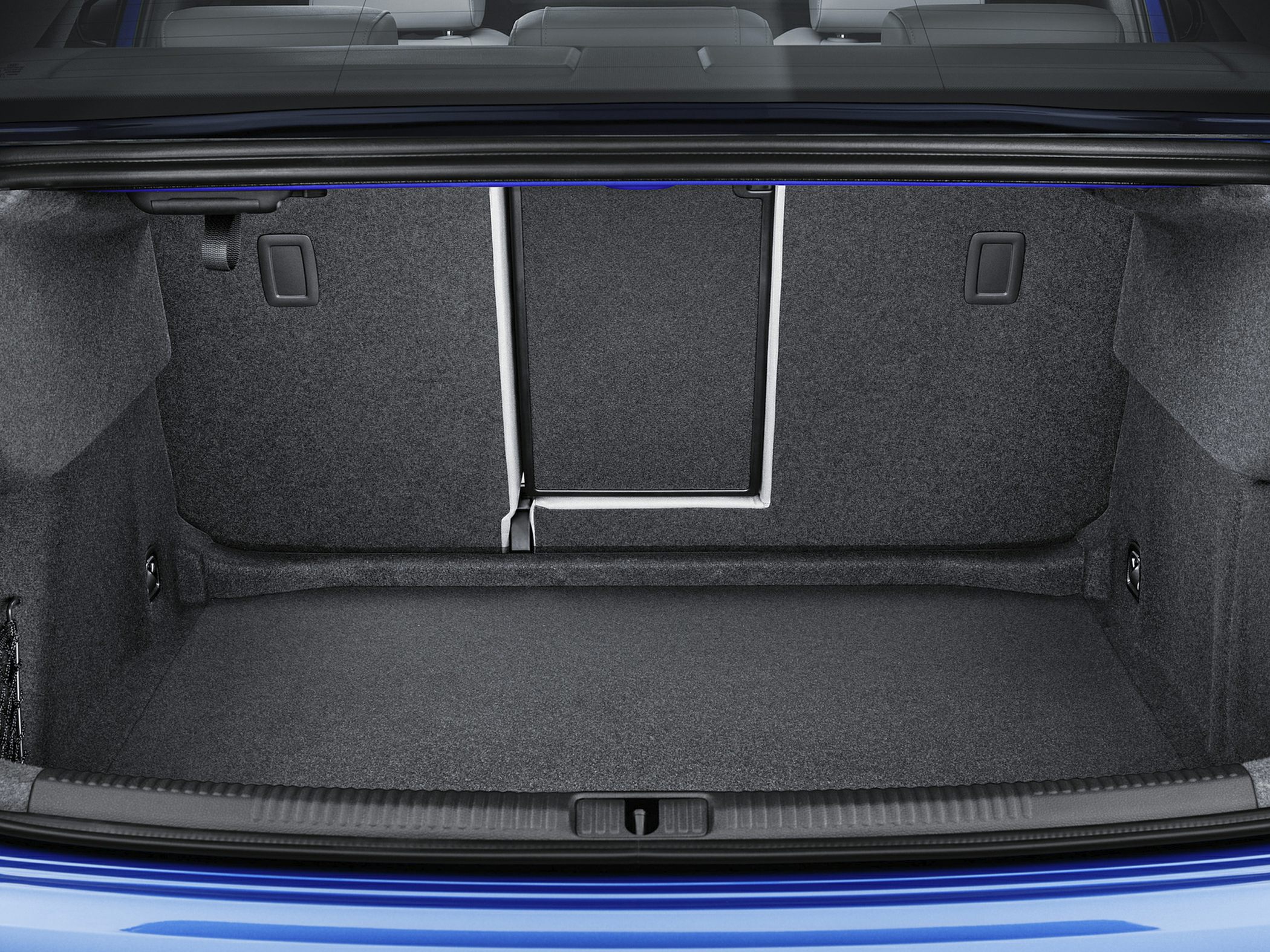 Spacious trunk interior with carpeted lining and fold-down rear seat pass-through