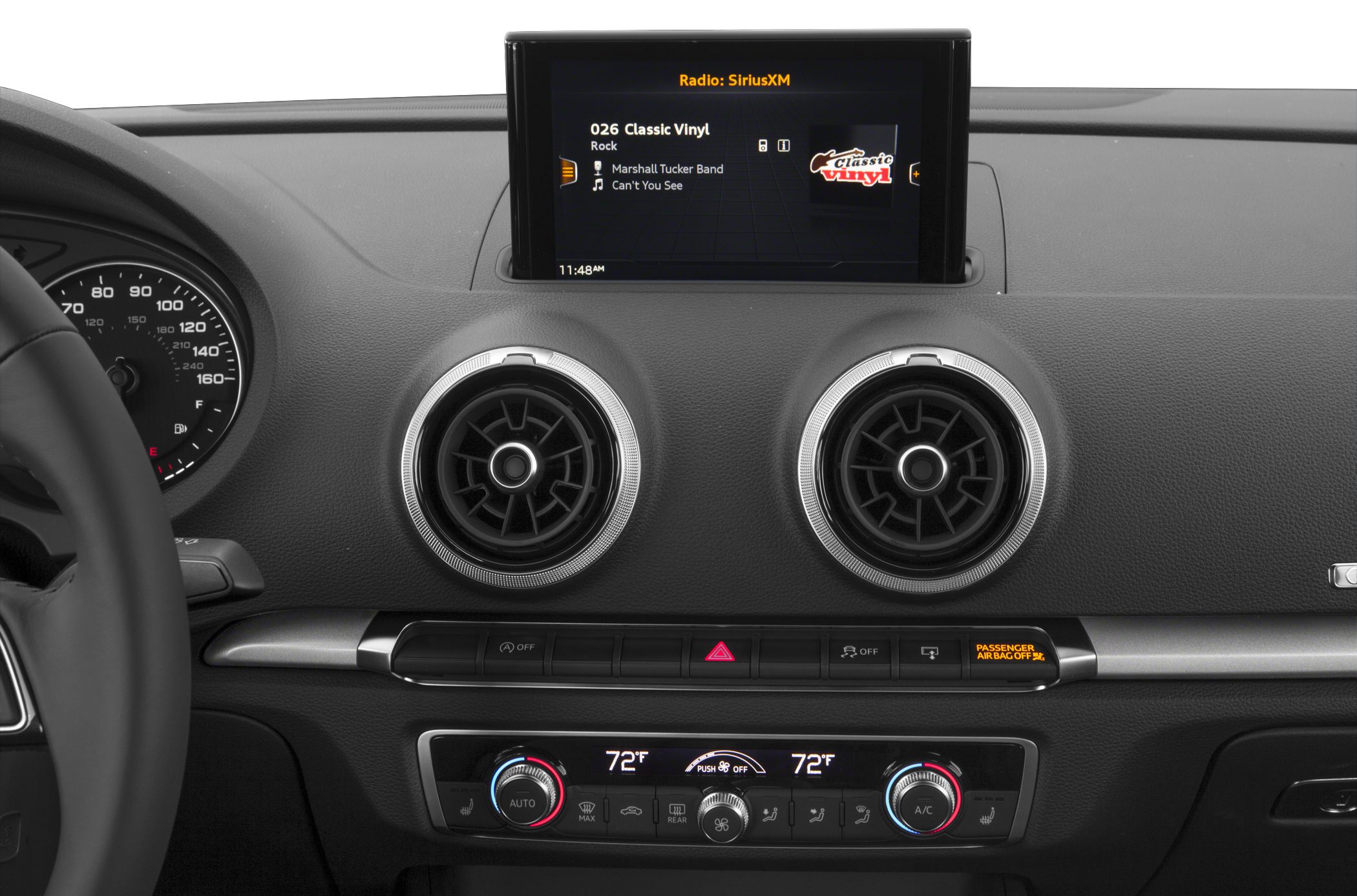 Circular air vents and infotainment screen on car dashboard