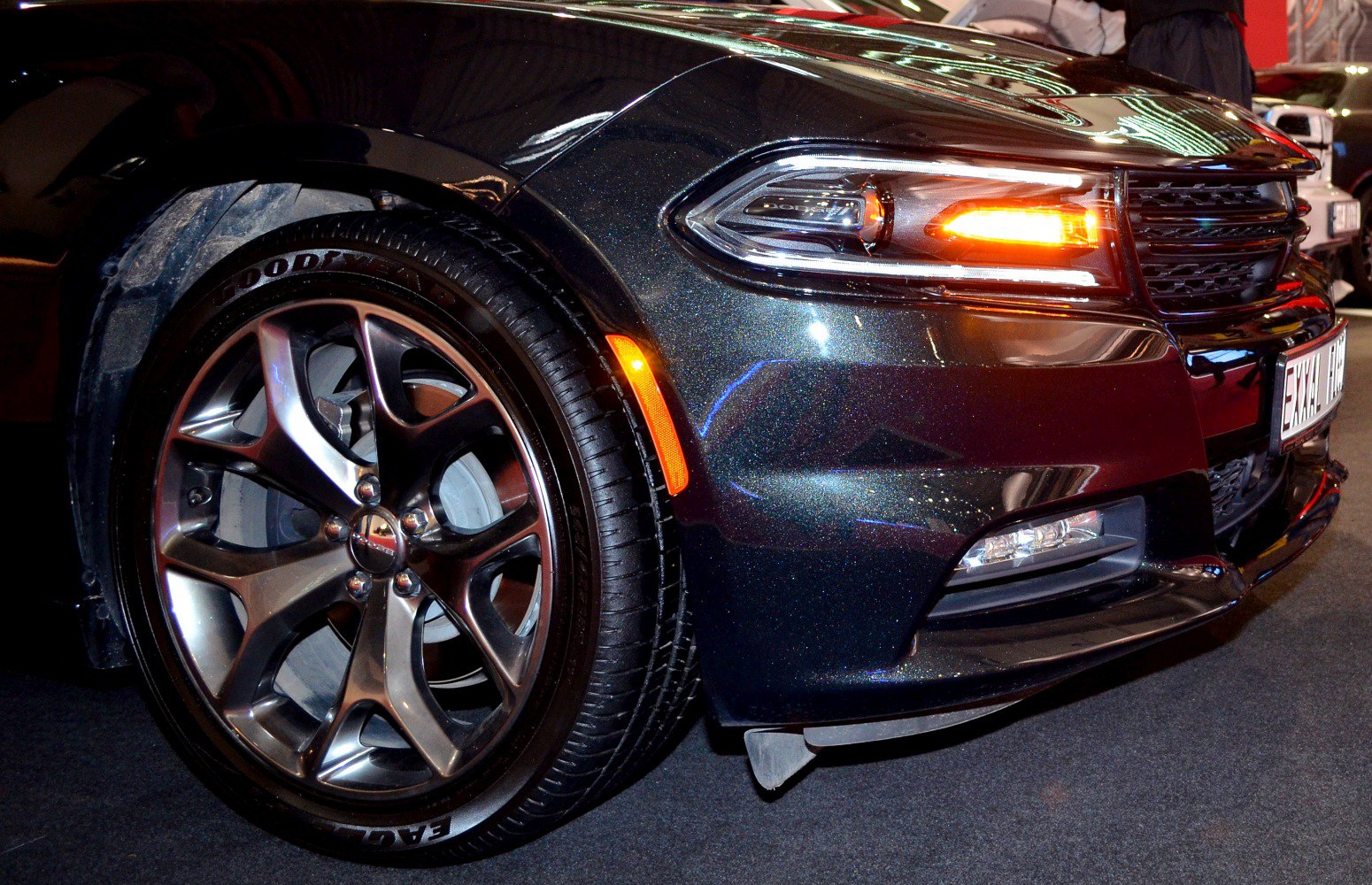 Front wheel with alloy rim and glowing LED headlight with turn signal