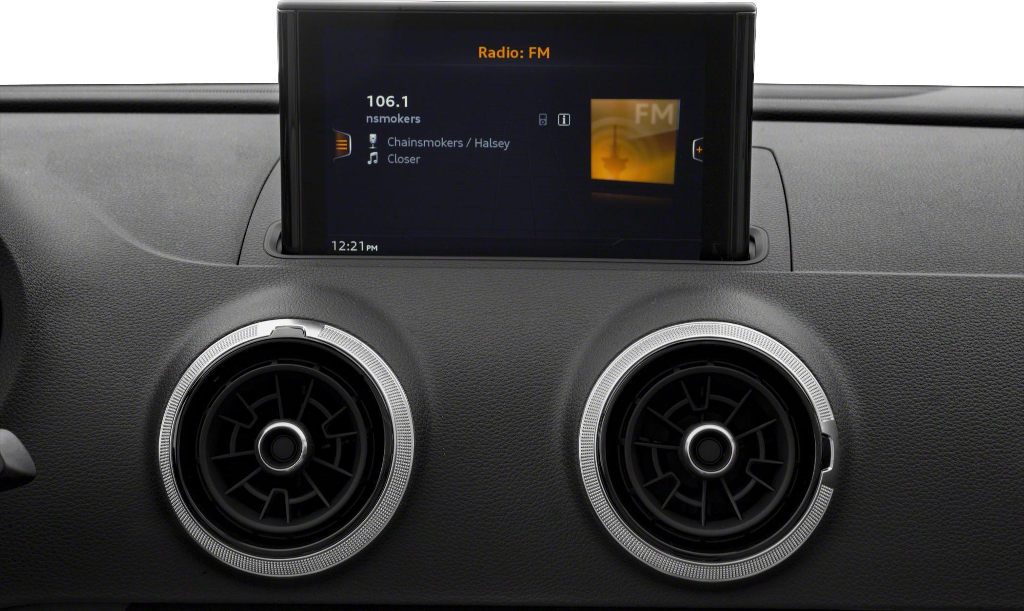 Round metallic-accented air vents and digital infotainment display with FM radio