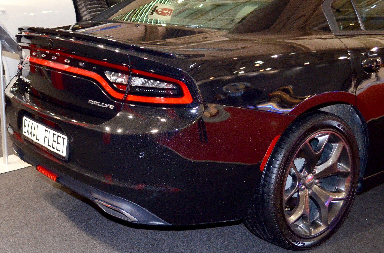 Rear taillight and alloy wheel of a black sports sedan
