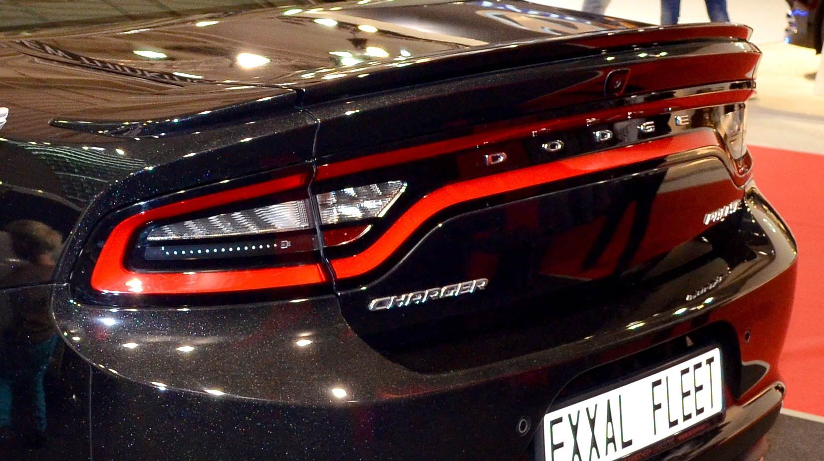 Rear light and trunk design with distinctive red trim and lettering
