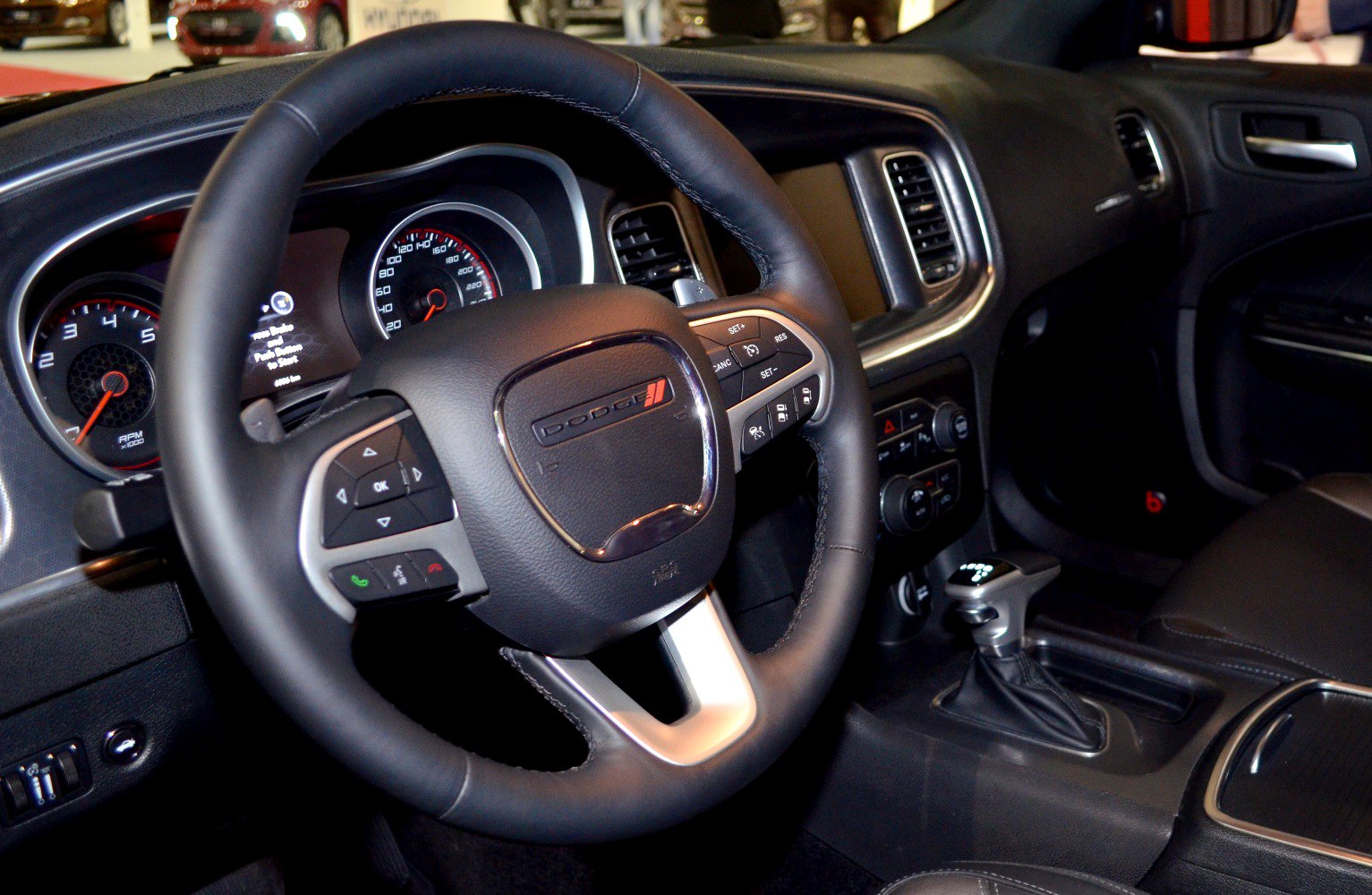 Steering wheel and dashboard with multifunction controls and speedometer