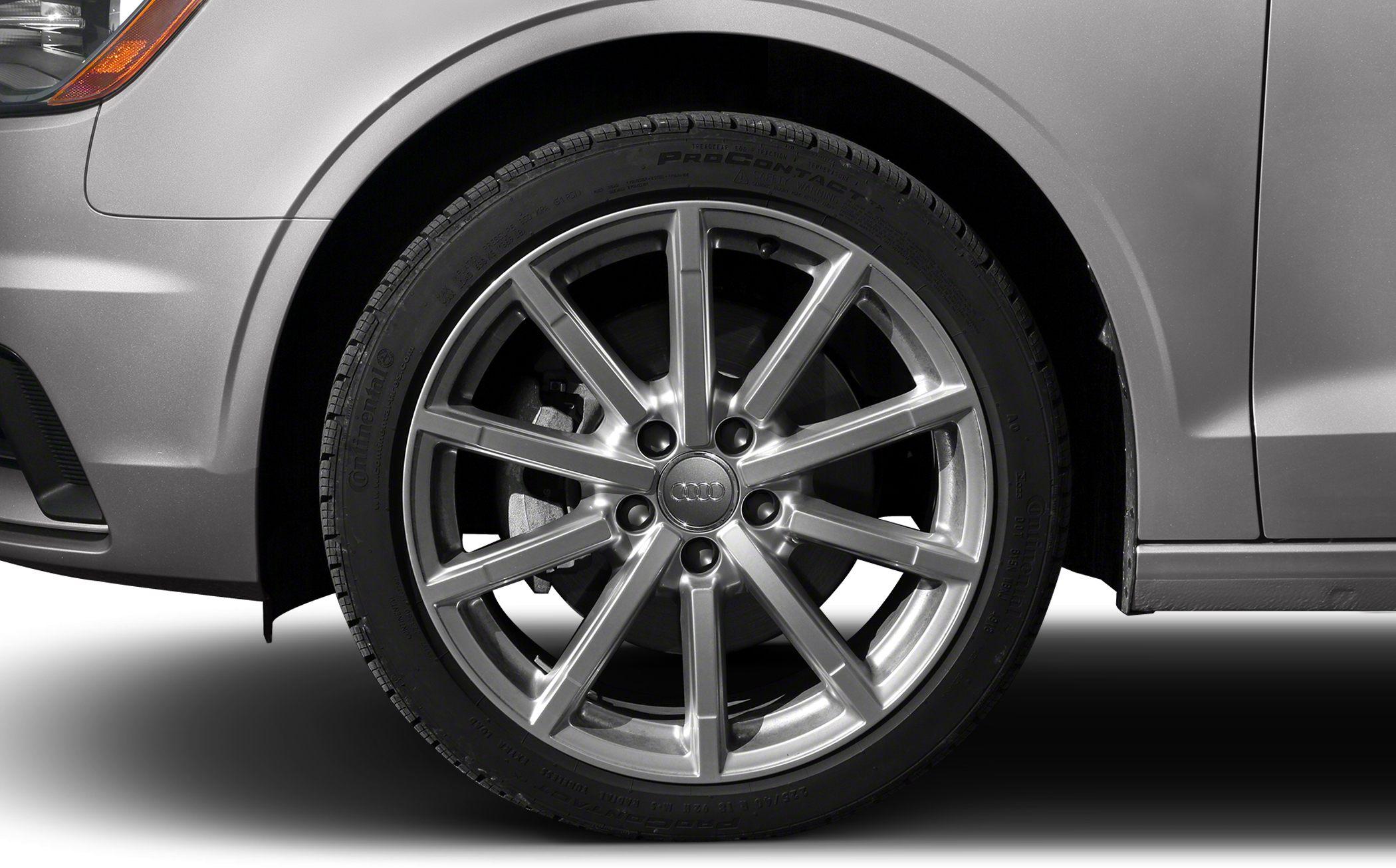 Close-up of alloy wheel and tire on a silver car