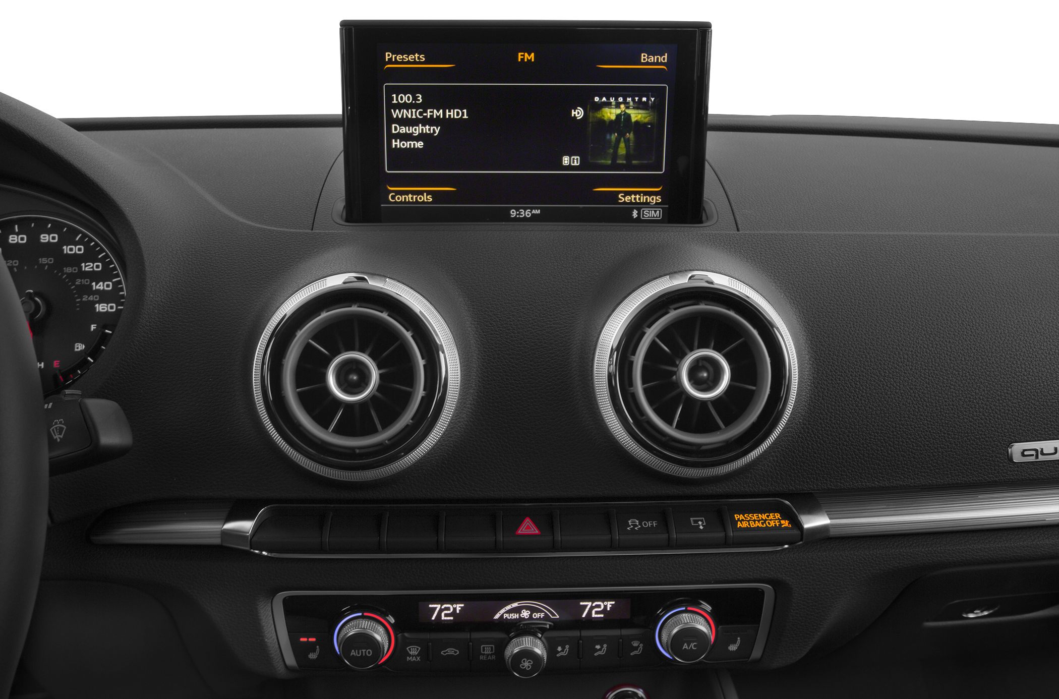 Dual round air vents, digital climate control, and infotainment screen on car dashboard