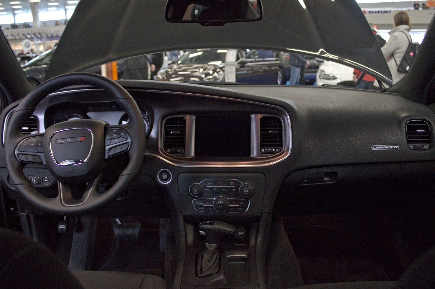 Dashboard and steering wheel with control buttons inside a vehicle