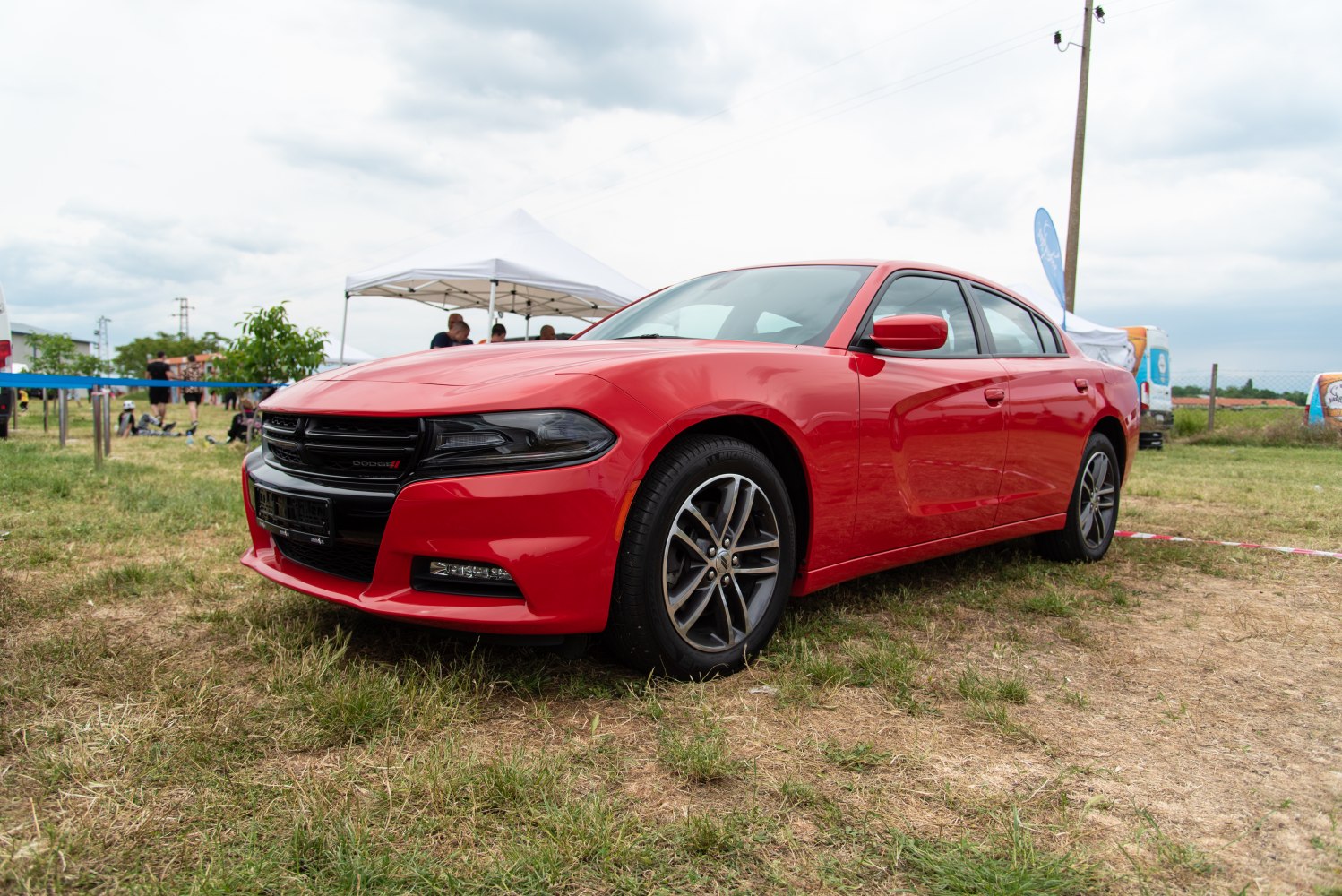 Red muscle sedan front angle with grille and wheels