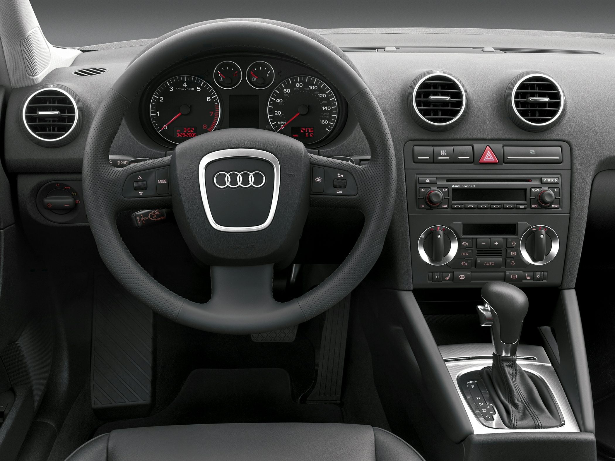 Audi interior dashboard with steering wheel, instrument cluster, and center console