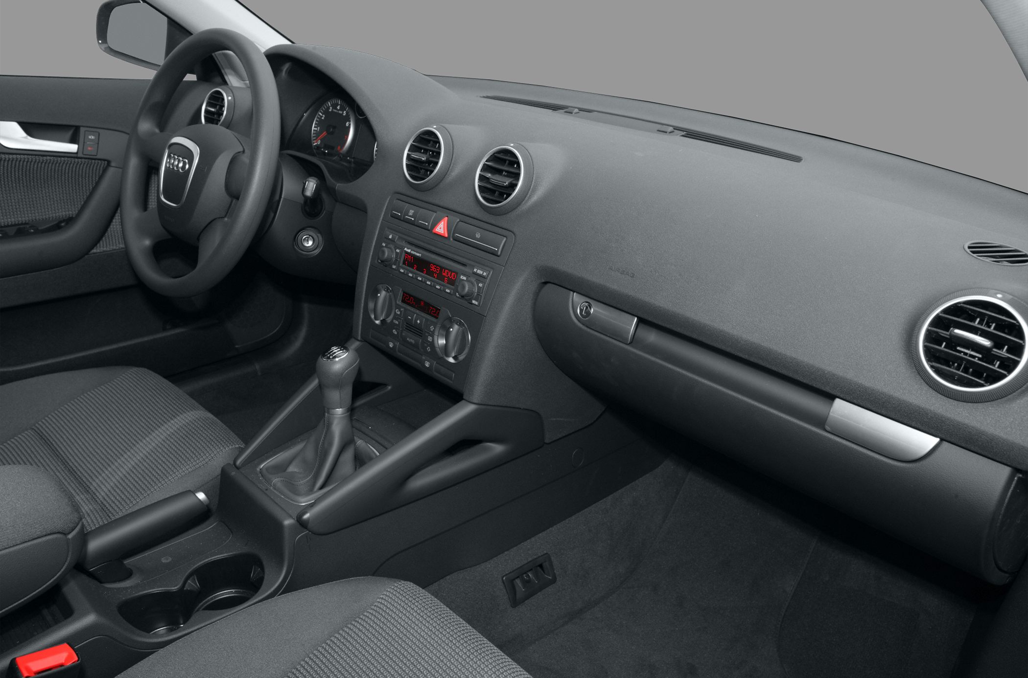 Dashboard with circular air vents and manual gear shift