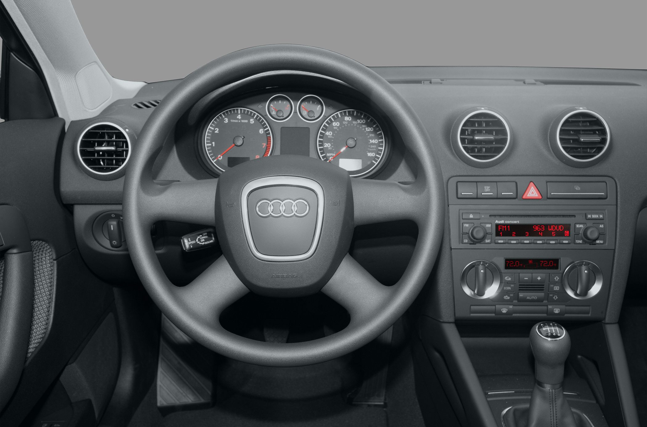 Dashboard, steering wheel, and center console with manual gear stick