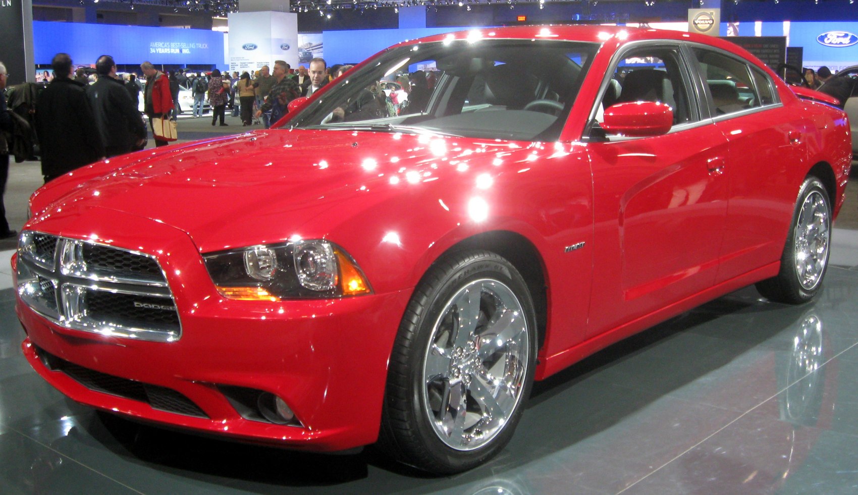 Chrome grille and modern headlights on a red four-door sedan.