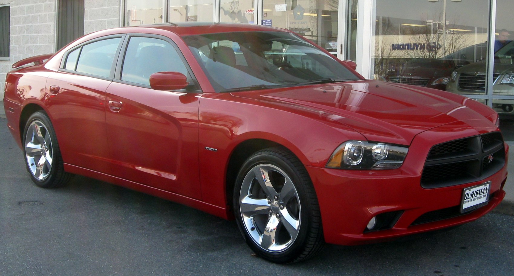 Red muscle sedan with chrome wheels front-side view