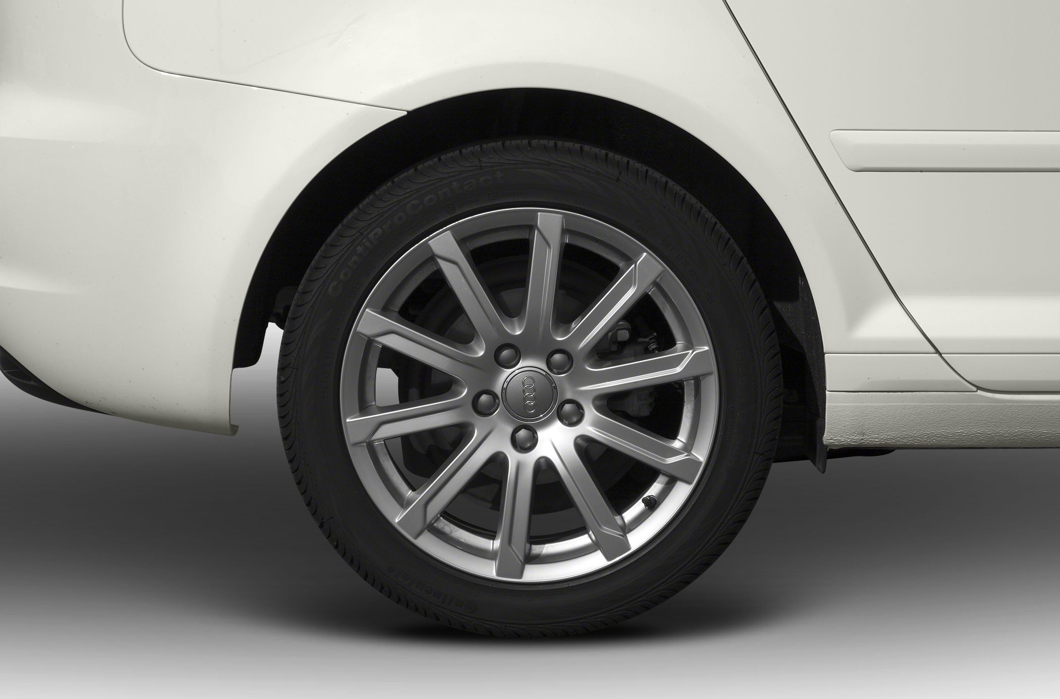 Close-up of a multi-spoke alloy wheel and rear tire section
