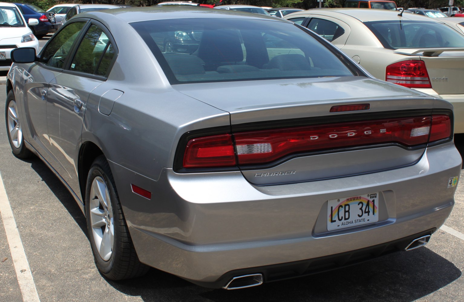 Rear view of silver sedan with distinctive taillights and dual exhaust