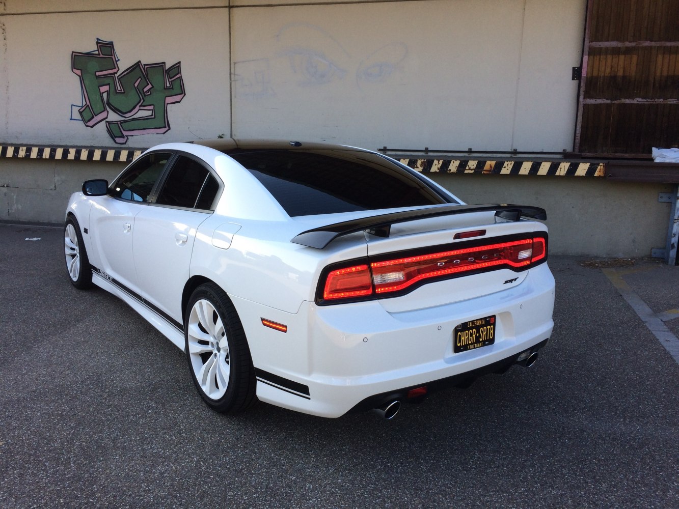 Rear view of modern sedan with rear spoiler and LED taillights