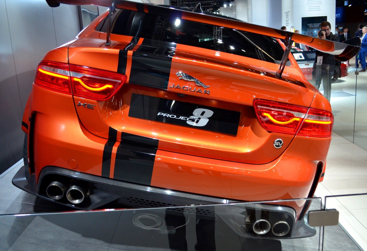 Rear view with large rear wing, quad exhaust, and sporty taillights