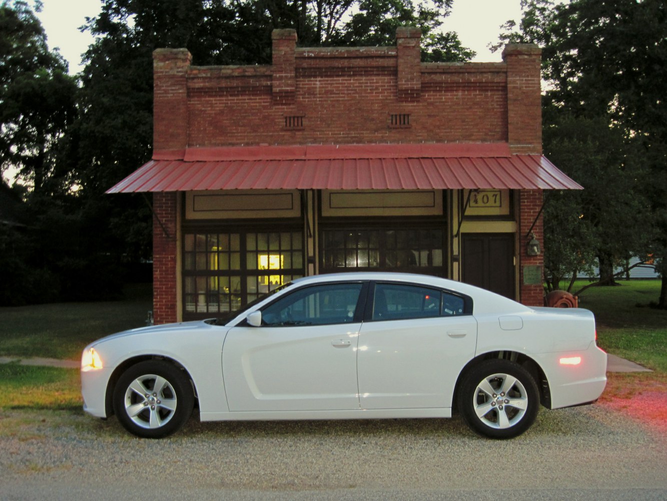 White four-door sedan with contoured side and alloy wheels.