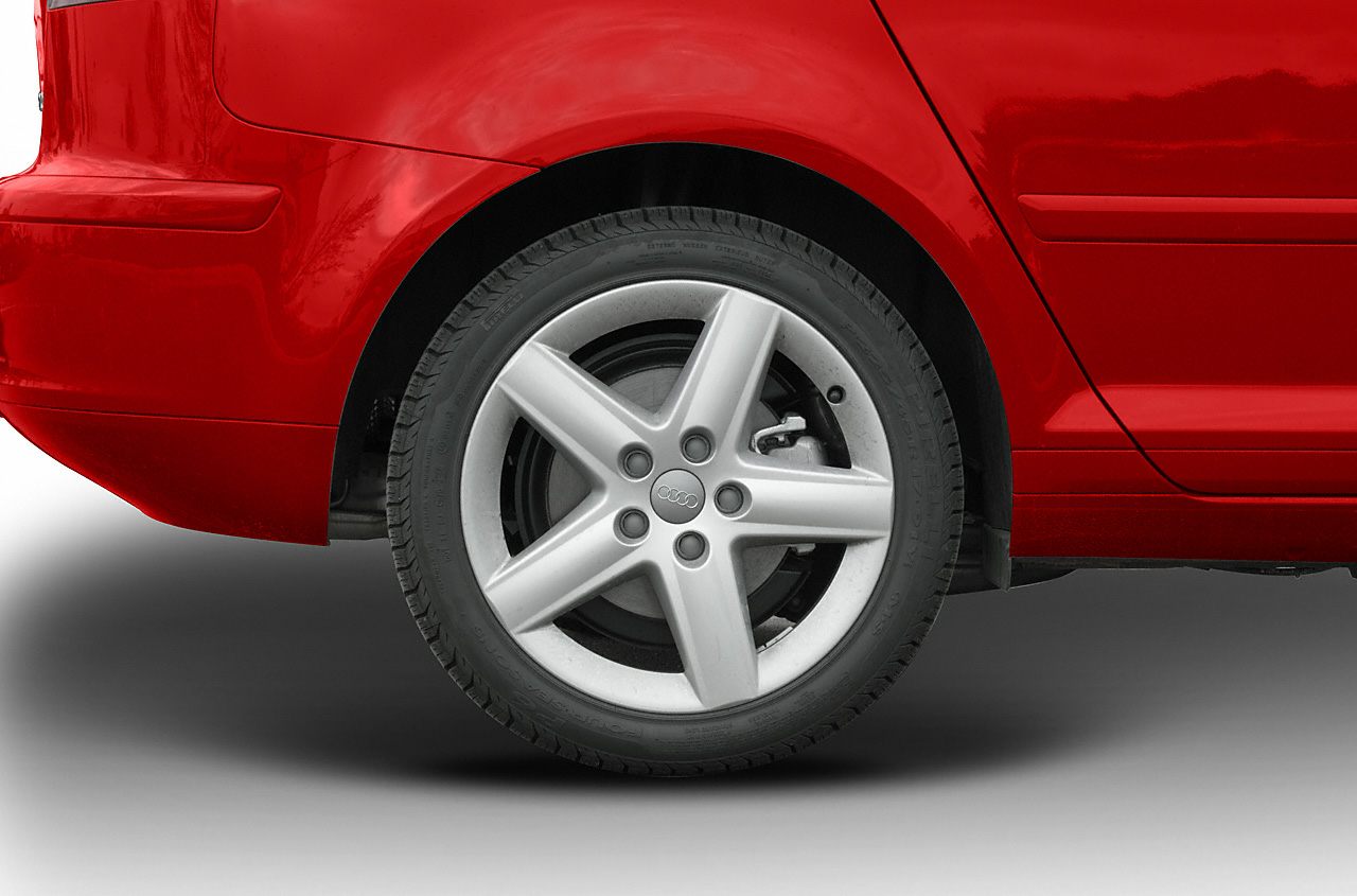 Silver 5-spoke alloy wheel on rear side of car