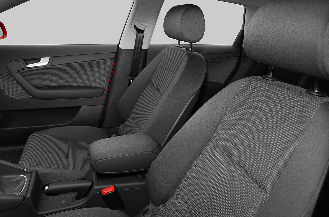 Front seats with fabric upholstery and center armrest in car interior