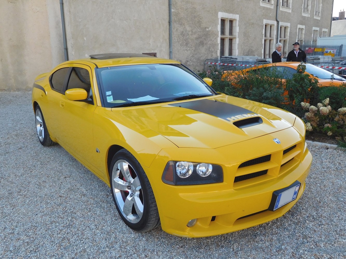 Yellow muscle car with hood scoop and chrome wheels