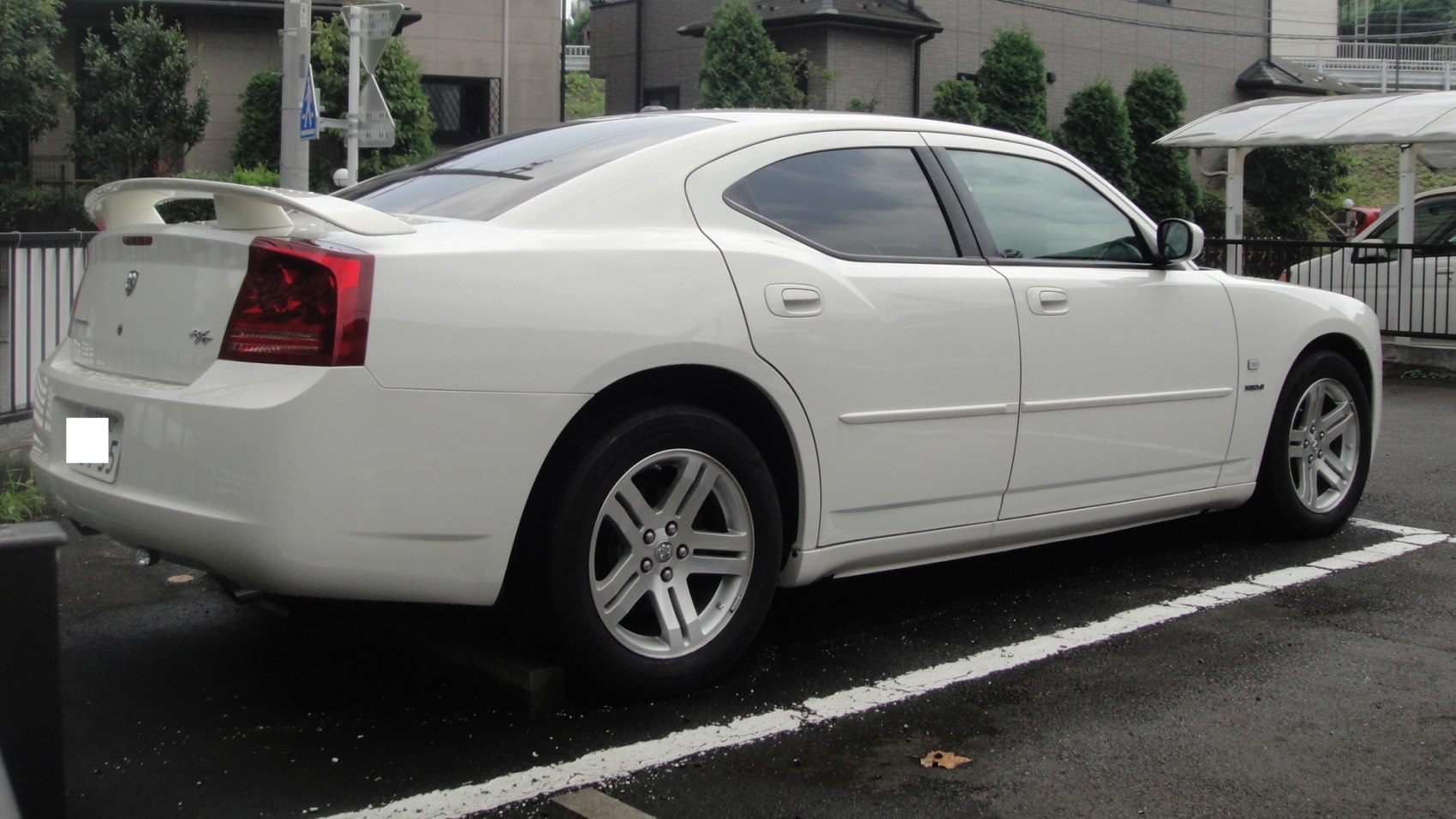 White sedan with rear spoiler and tinted windows