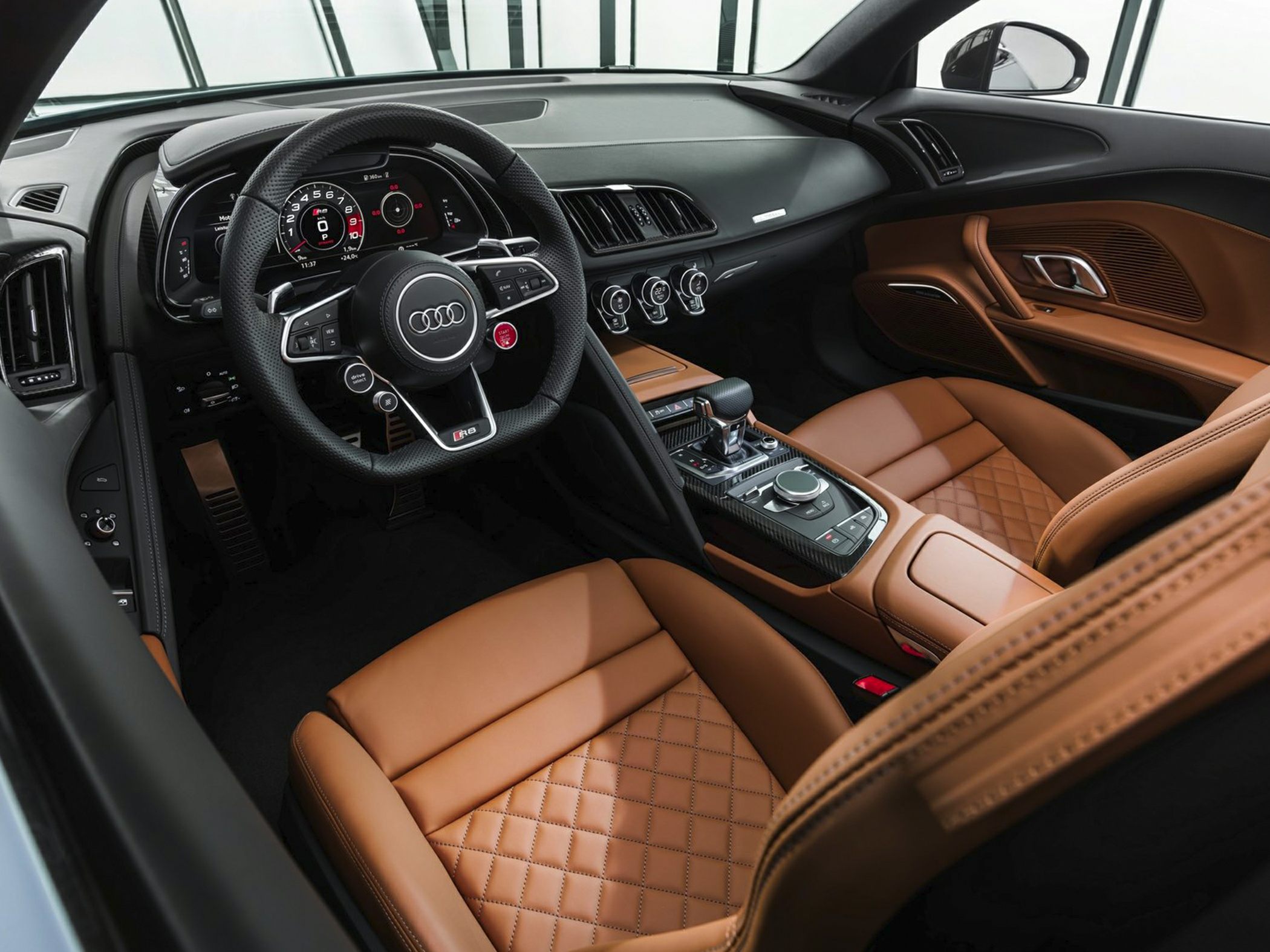 Quilted brown leather seats and digital instrument cluster in luxury sports car interior