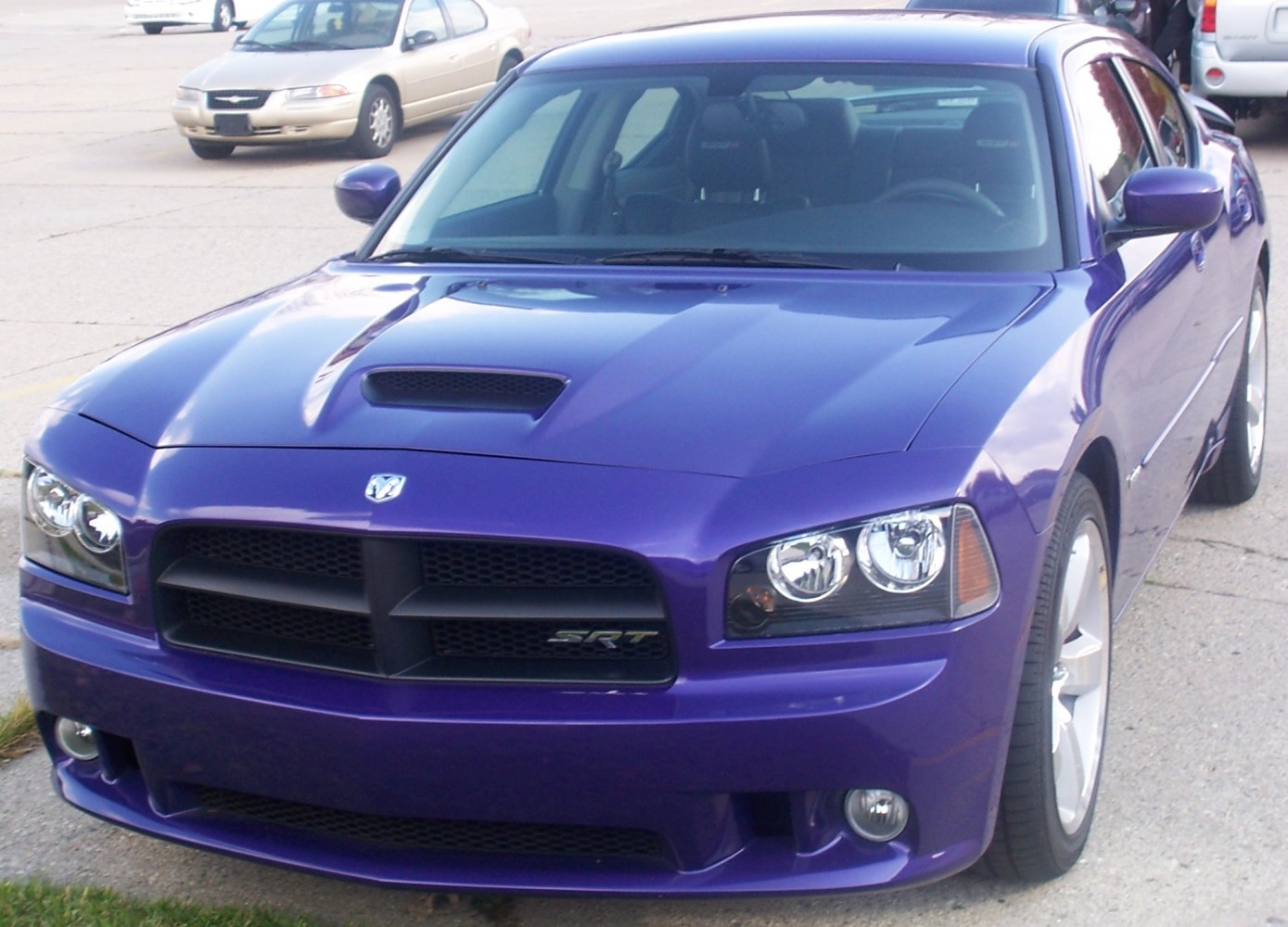 Front view of muscle car with hood scoop and SRT badge