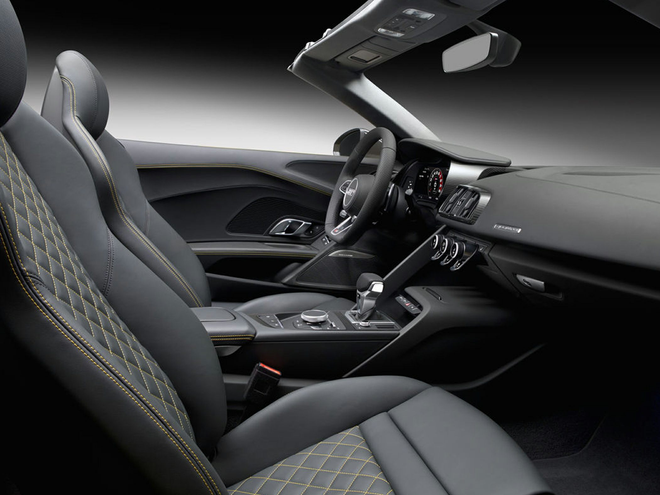 Luxury sports car interior with diamond-stitched seats and modern cockpit design