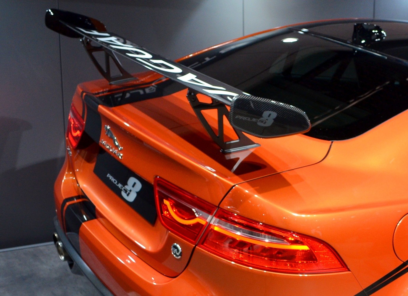 Rear end with large carbon fiber spoiler and illuminated tail lights