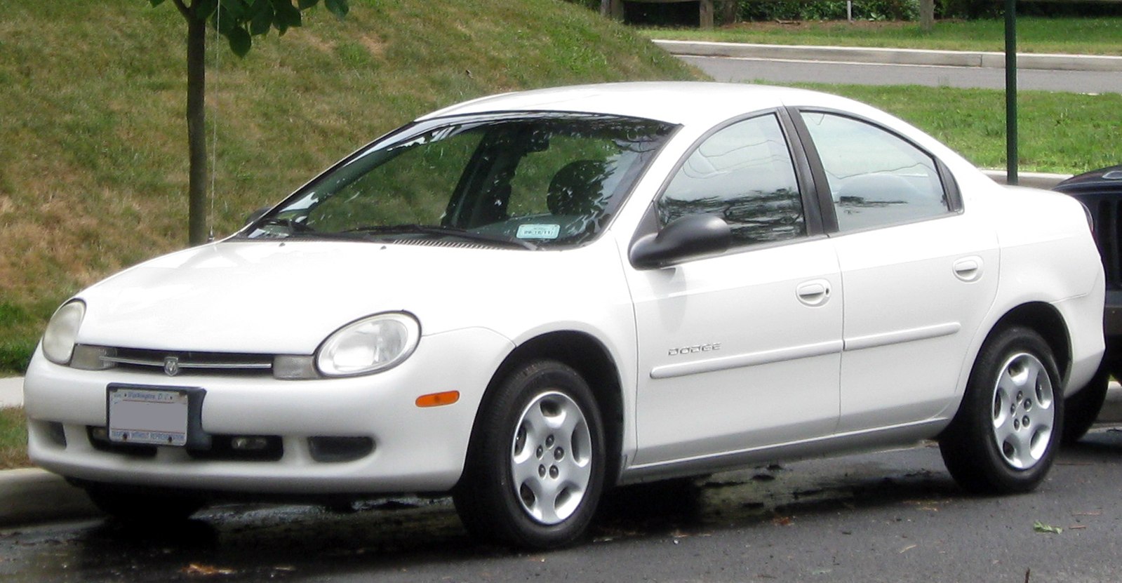 White compact sedan with oval headlamps and smooth body lines.