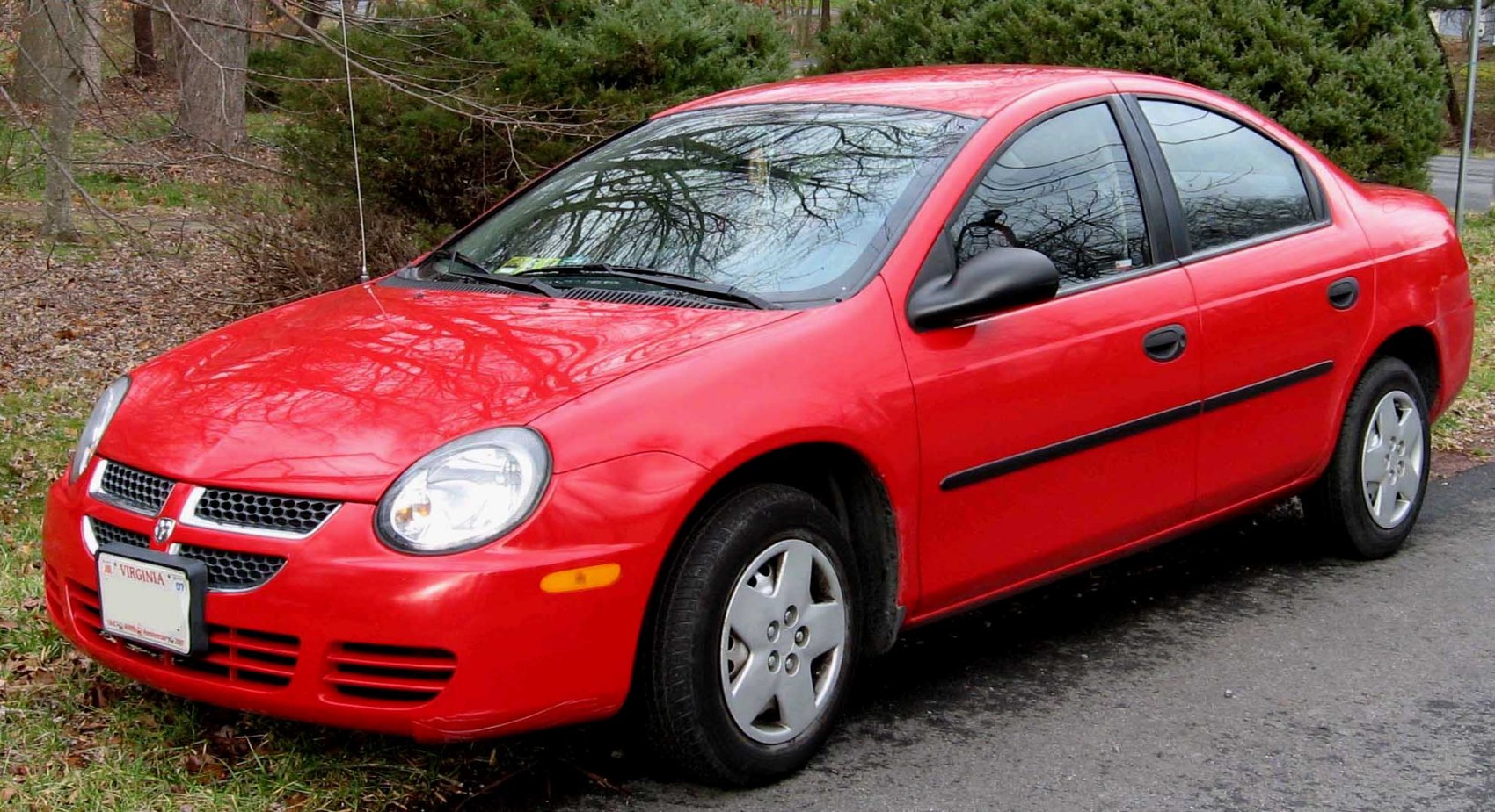 Compact sedan with rounded headlights and basic wheel covers