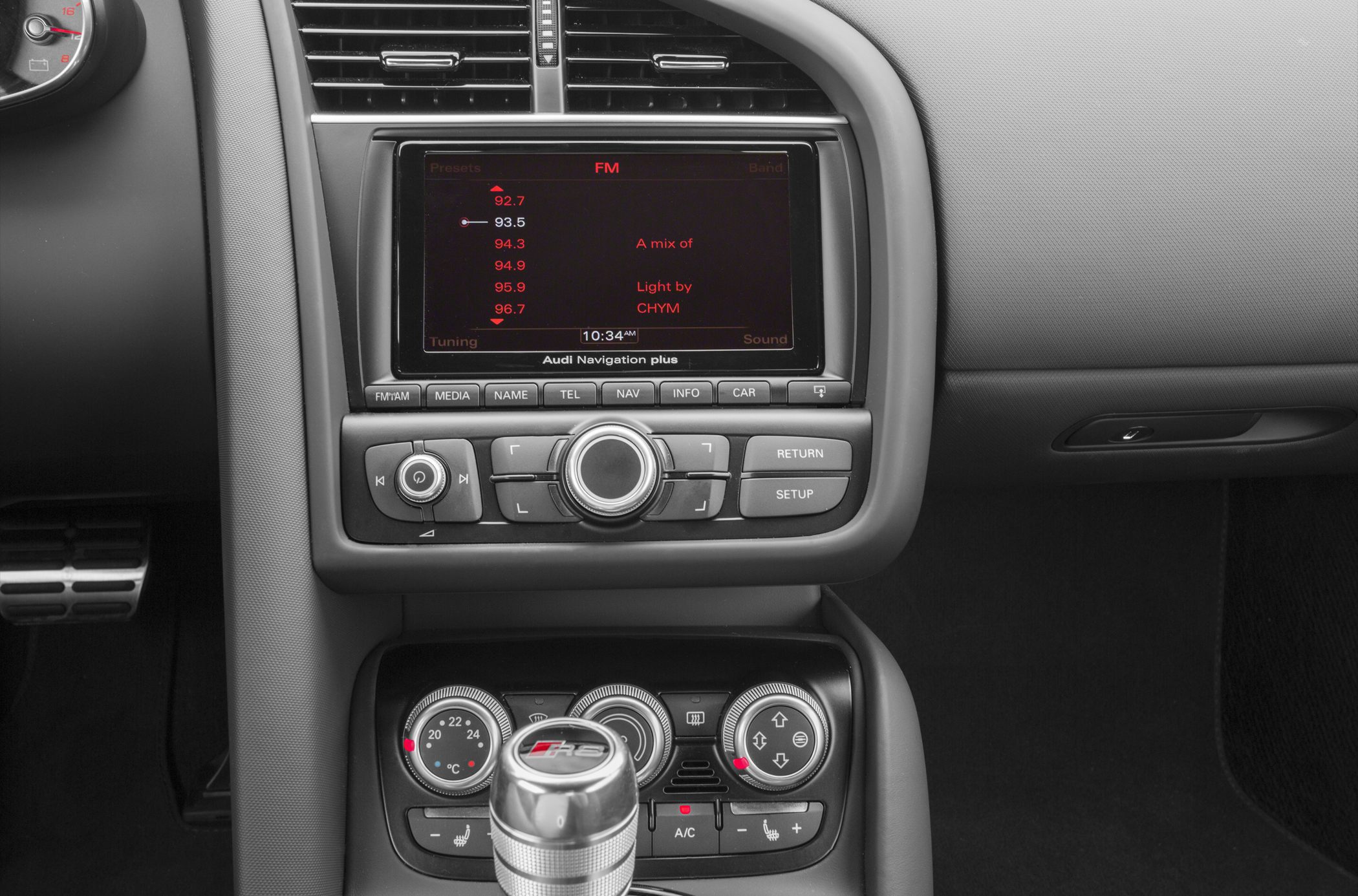 Navigation system, climate control dials, and R8 gear shift knob in sports car interior