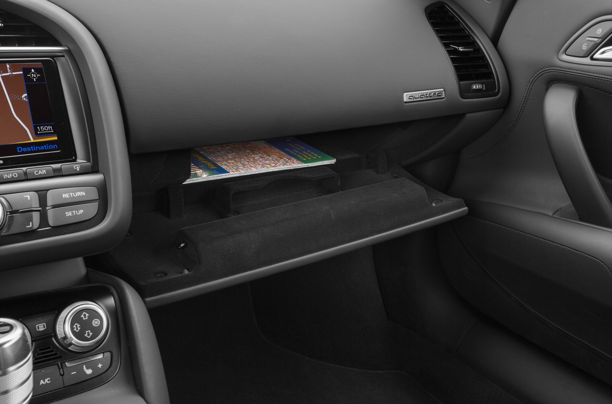 Open glove compartment and car dashboard with navigation screen
