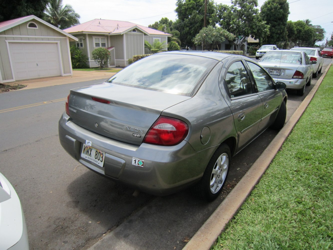 Rear view of a compact sedan showcasing taillights, trunk, and license plate