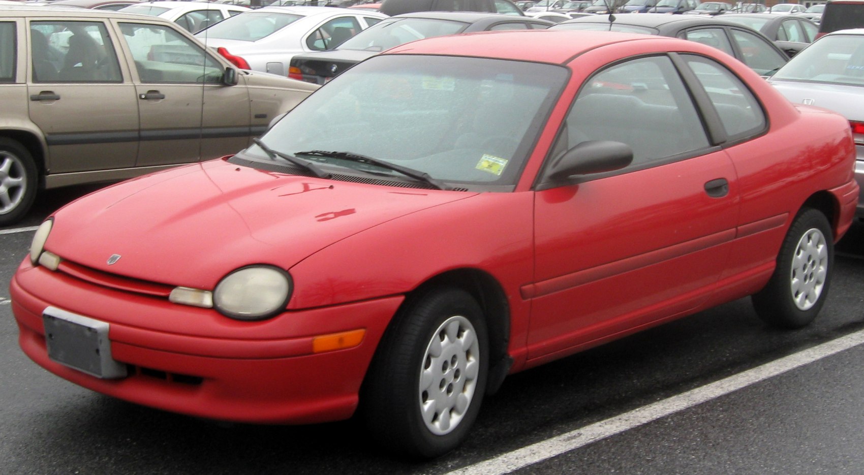 Red two-door coupe with rounded headlights and compact body.