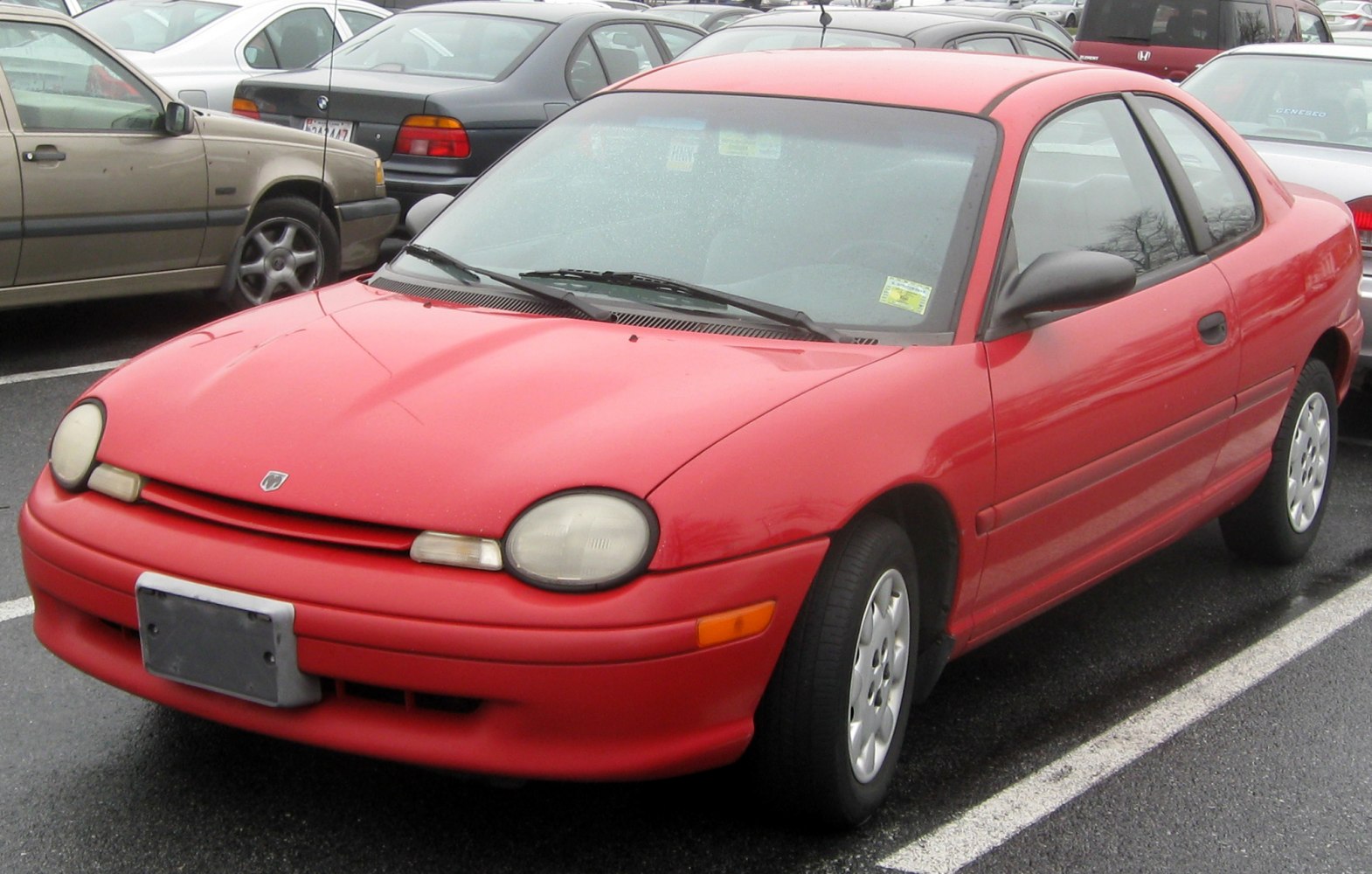 Red coupe with rounded headlights and smooth body lines.