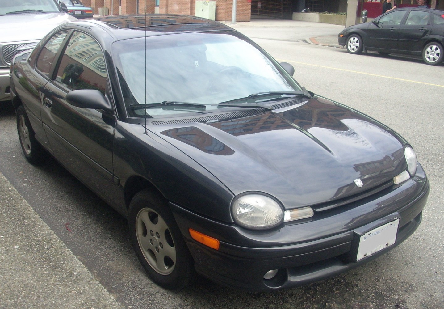 Front and side view of a compact sedan with round headlights and sleek body lines
