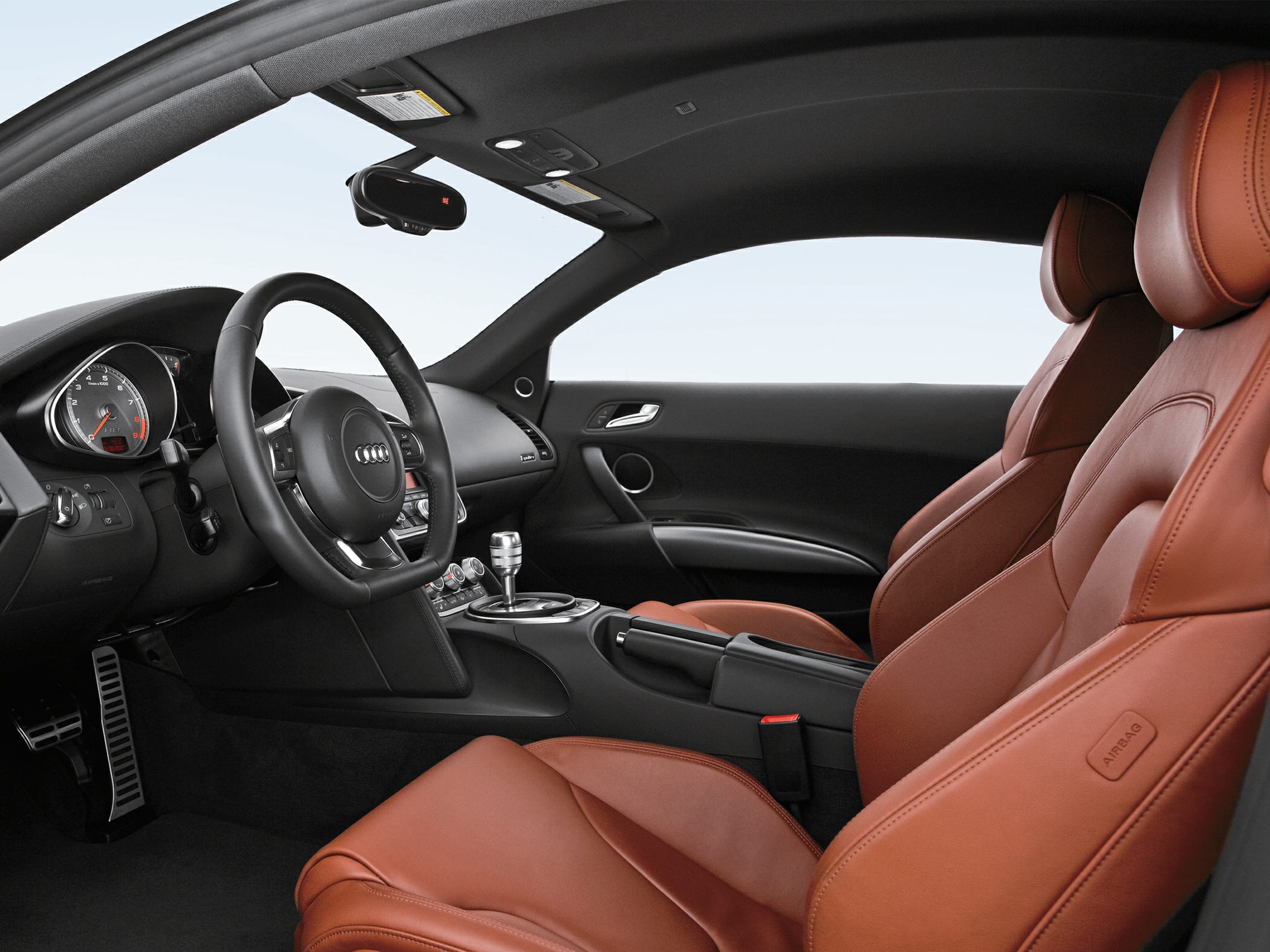 Leather sports seats and sleek black dashboard with steering wheel and gear shifter