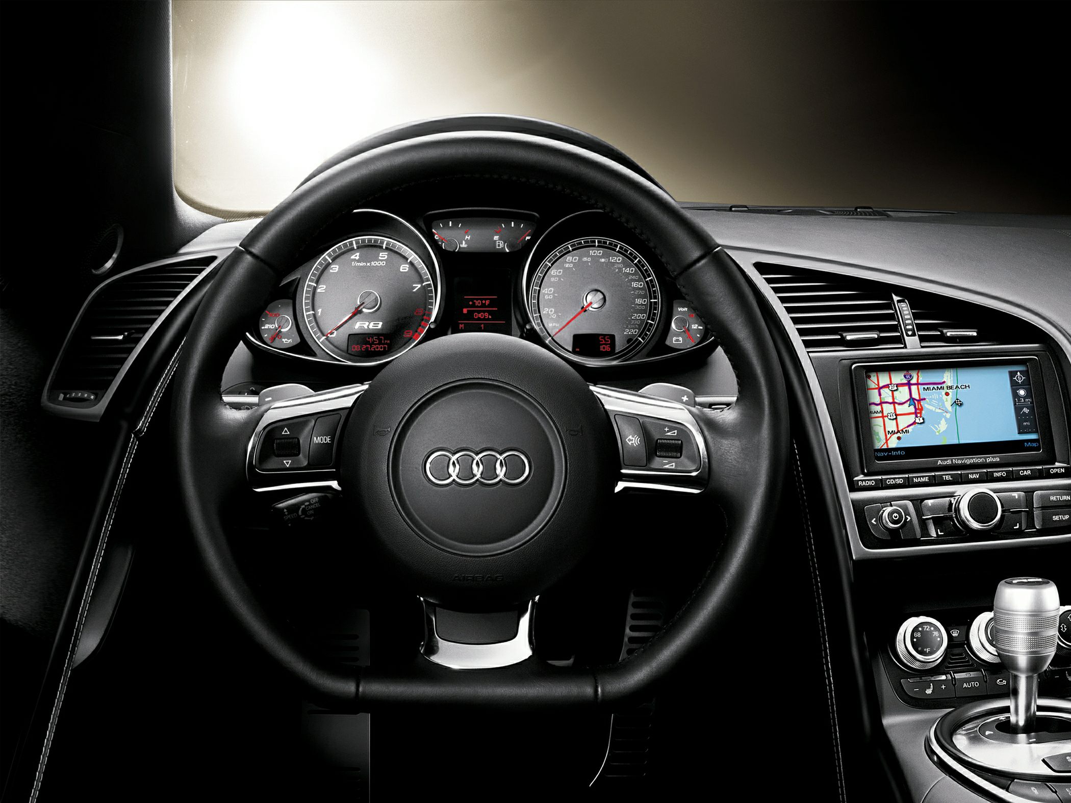 Steering wheel, instrument cluster, and navigation display inside a sports car