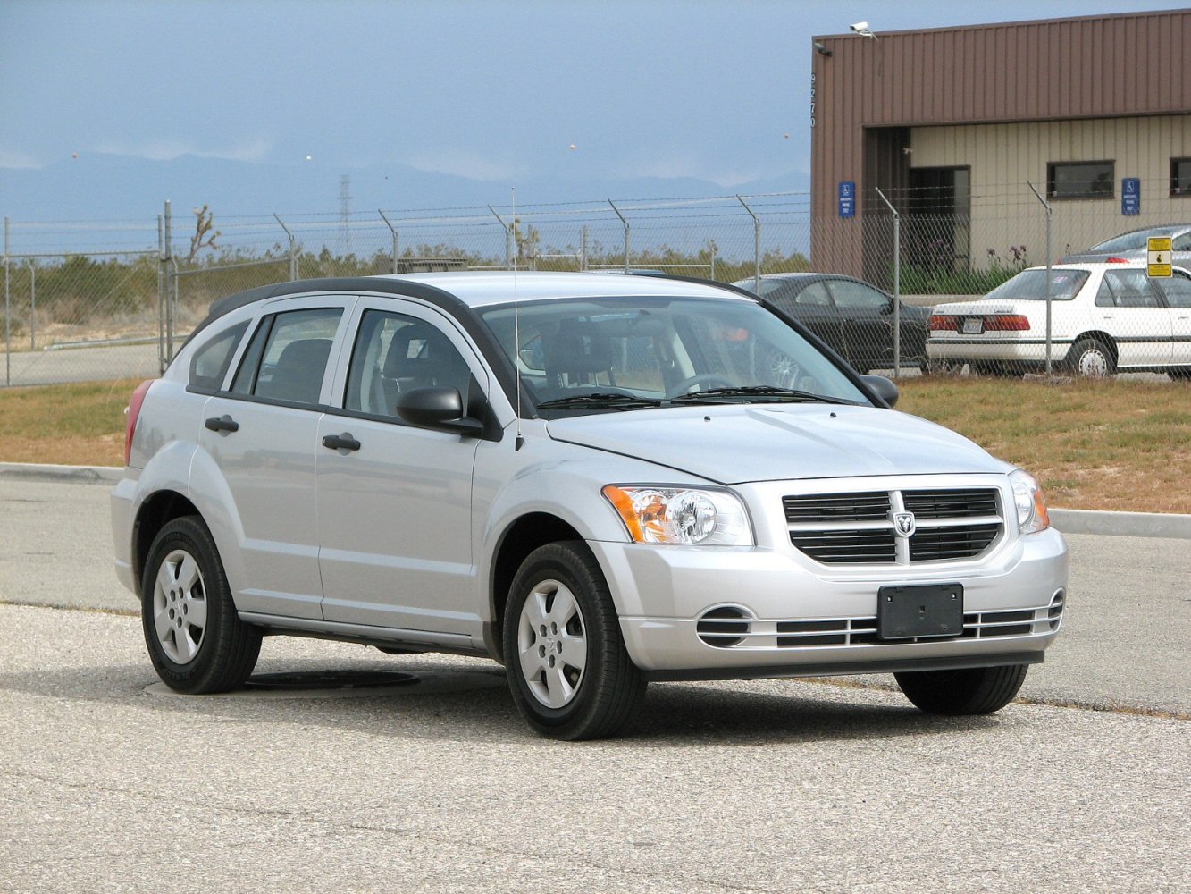 Silver compact hatchback with bold front grille and clear headlights