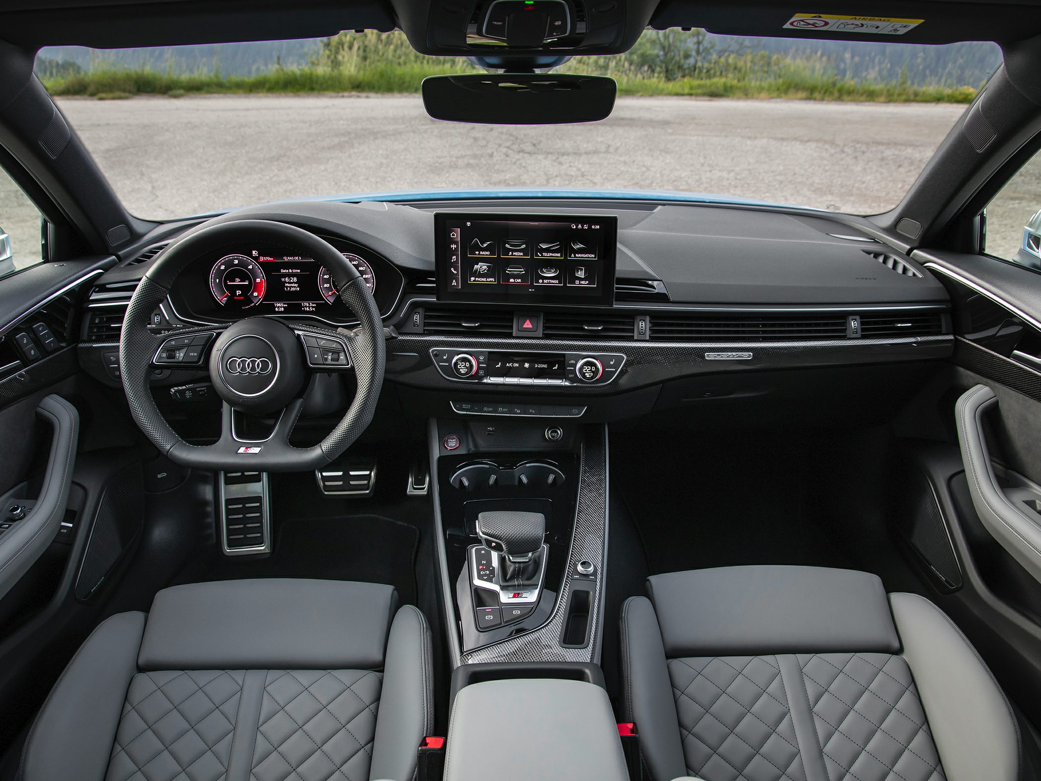 Digital instrument cluster and sport steering wheel with carbon fiber trim interior.