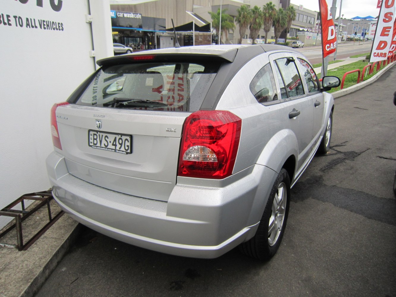 Compact hatchback rear with angular tail lights and rear window wiper