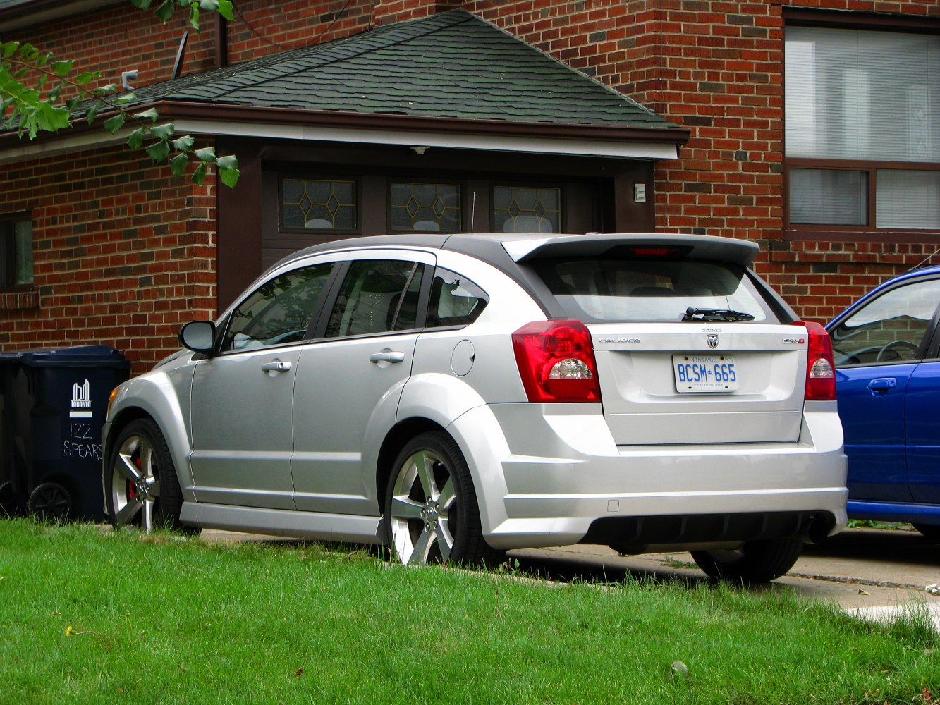 Rear view of a compact hatchback with spoiler and alloy wheels