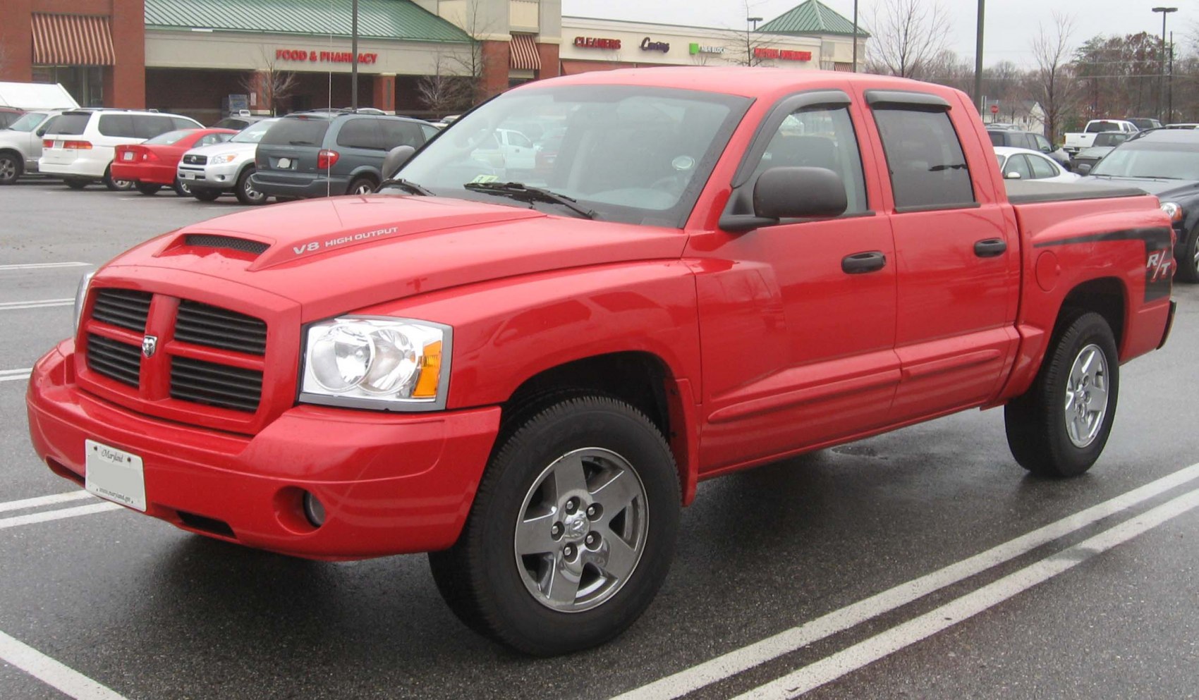Side-front view of a red crew cab pickup with V8 badge and R/T decal
