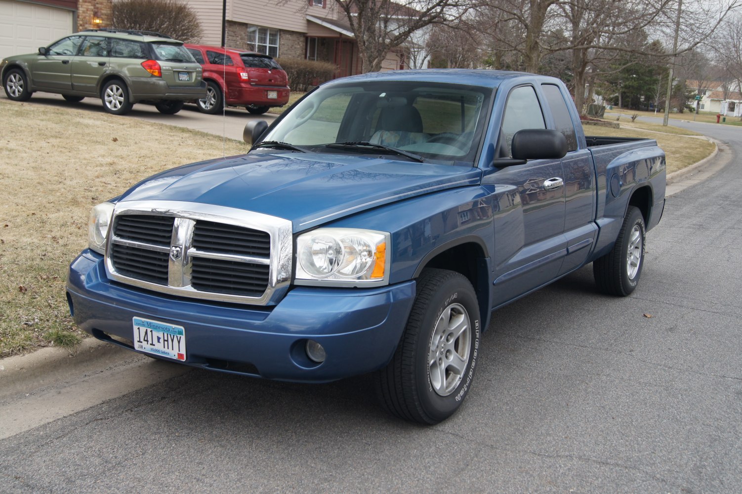 Blue pickup with extended cab and chrome grille front