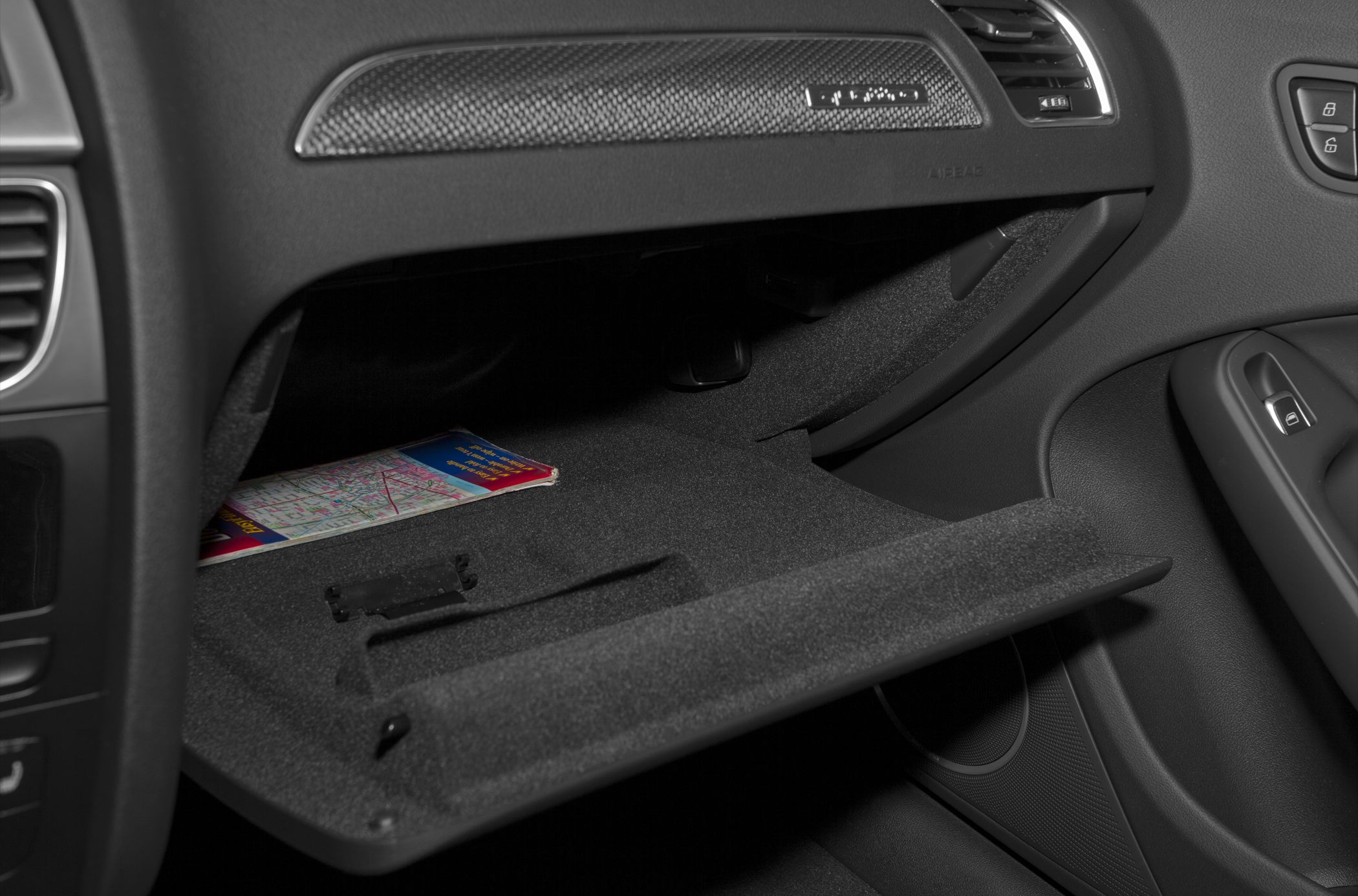 Glove compartment and textured dashboard trim in a car interior