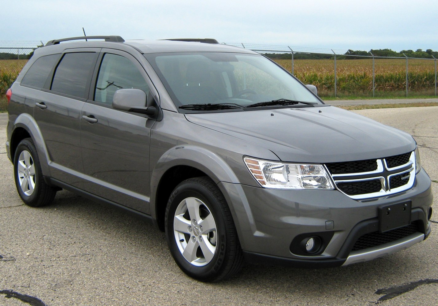 Gray SUV with roof rails and alloy wheels shown from front three-quarter view