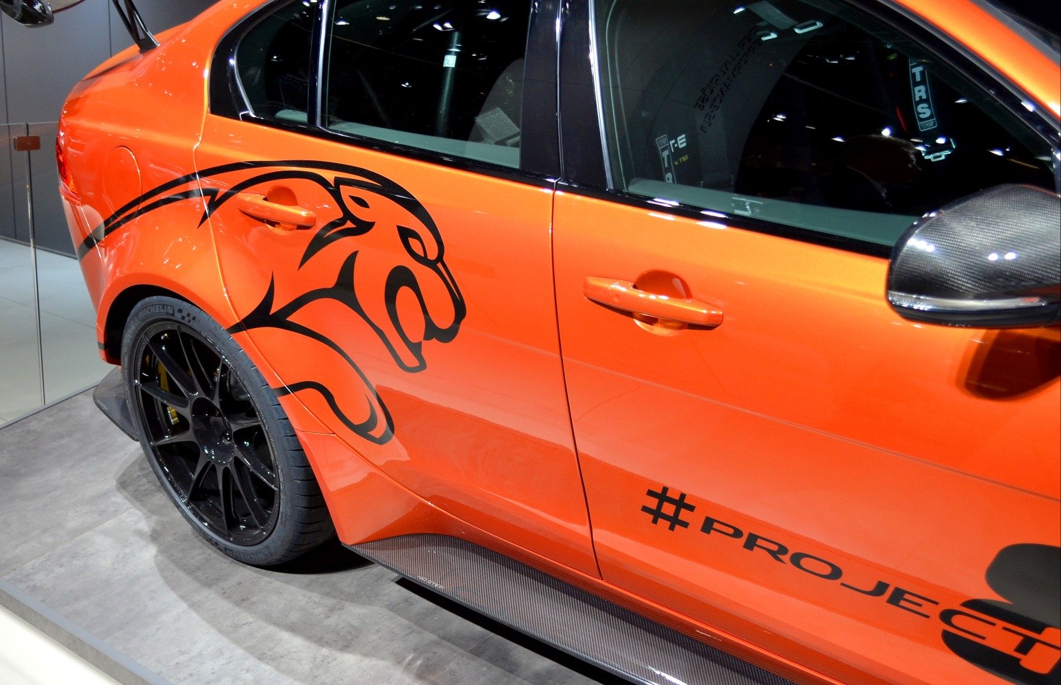 Custom orange side with black cat graphic and black alloy wheel