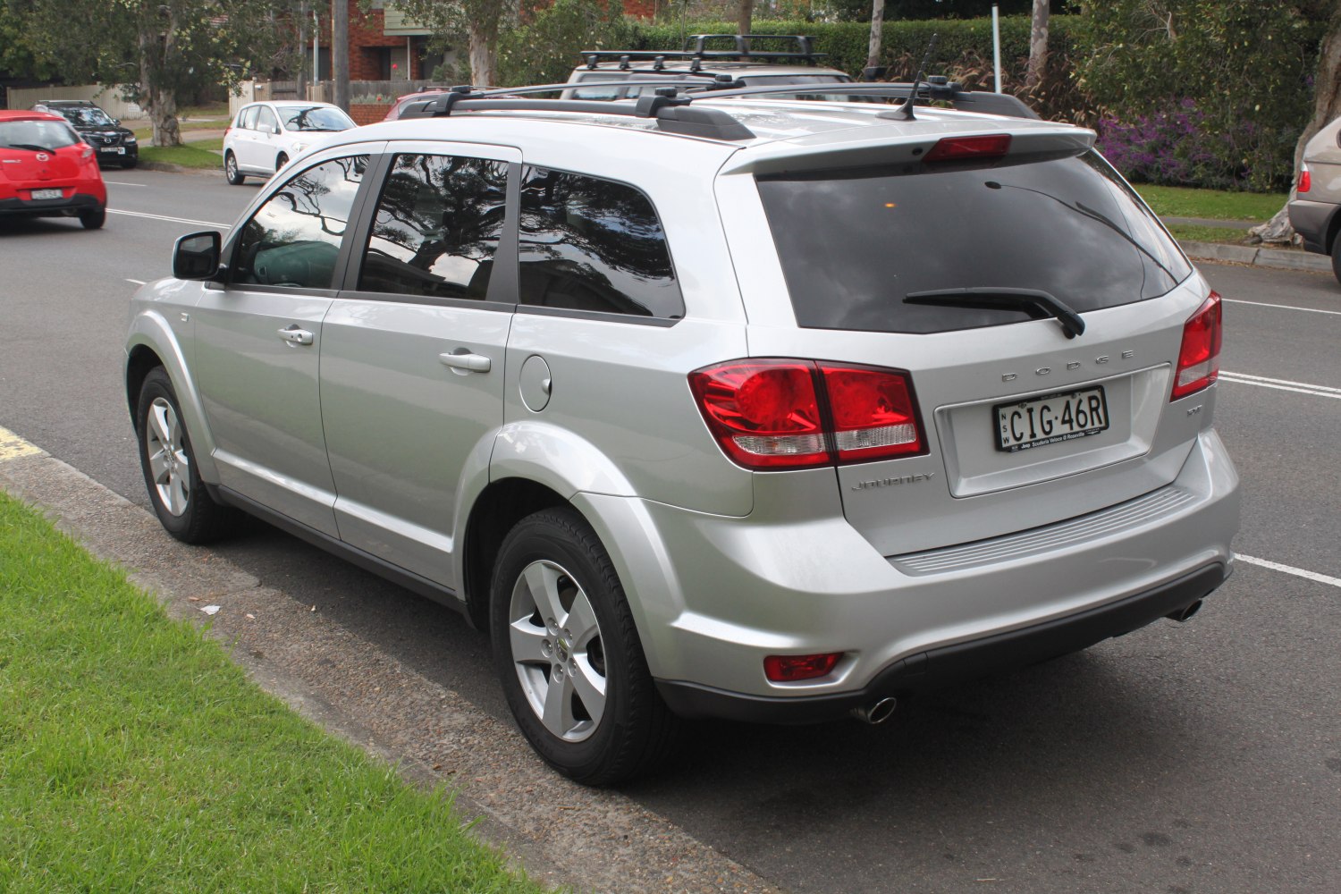Rear view of an SUV with roof rails and dual exhaust